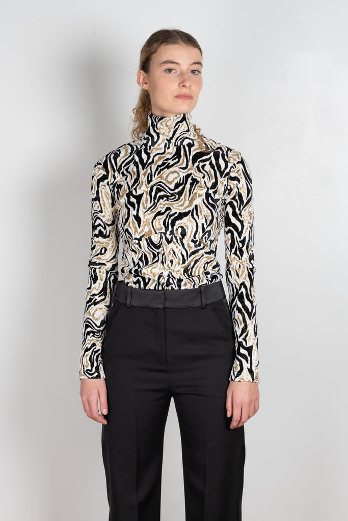 The turtleneck top by Paco Rabanne is a structured jacquard top in a black, gold and cream print