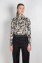 The turtleneck top by Paco Rabanne is a structured jacquard top in a black, gold and cream print