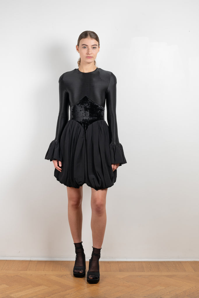 The Velvet Panel Mini Dress by Paco Rabanne is a short dress with a velvet panel, a puffed skirt and long flared sleeves