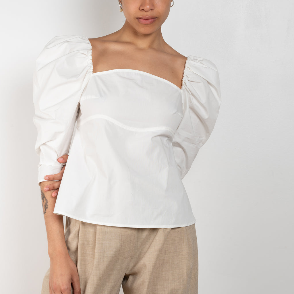 The Anita Blouse by Rejina Pyo is a crisp cotton top with a square neckline and puffed sleeves