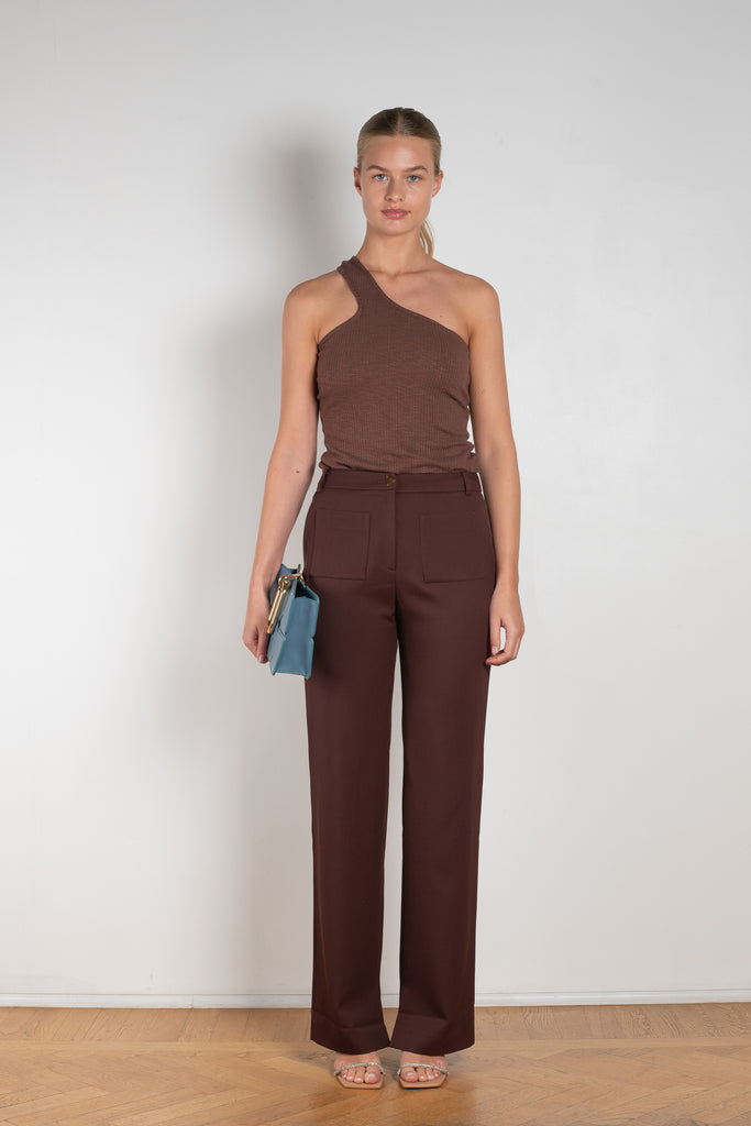 The Ellis Trousers by Rejina Pyo is a high waisted suiting trouser with a straight leg and signature button in a wool twill blend