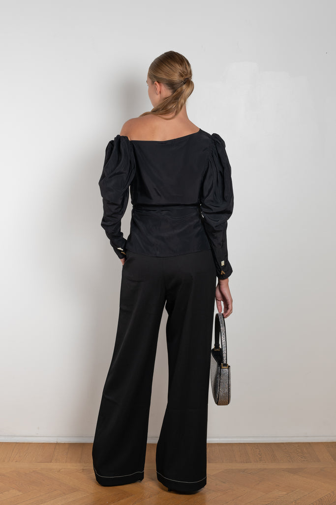 The Fiona Top by Rejina Pyo is a one-shoulder top with long puff sleeves, a tie detail to cinch the waist and exaggerated cuffs