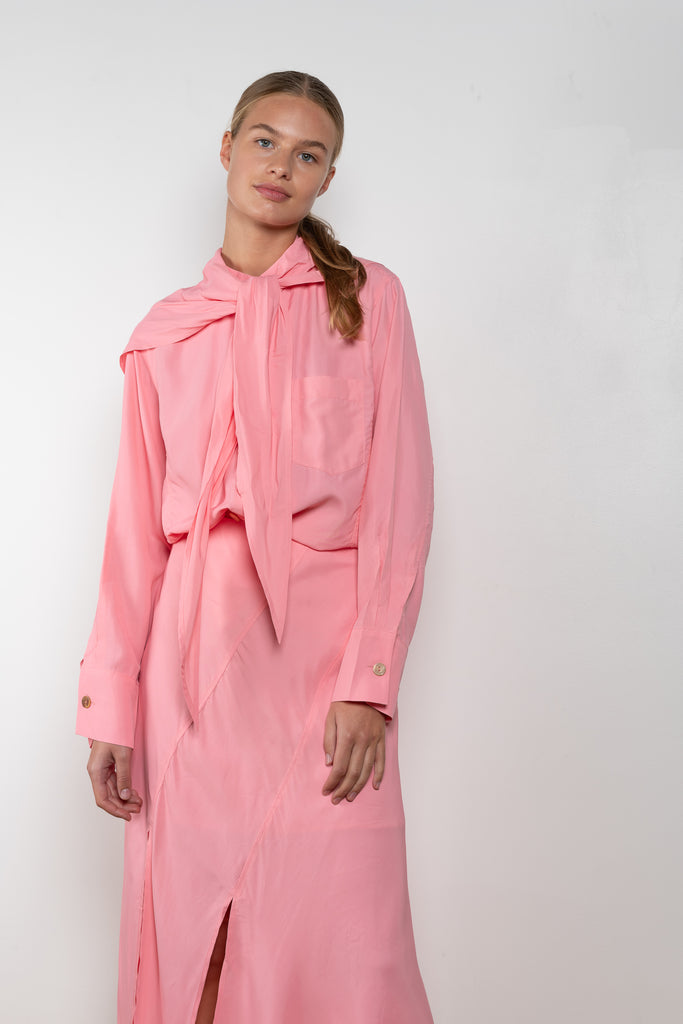 The Jolene Top by Rejina Pyo is a loose top with long sleeves and a fabric overlay scarf detail in a pink fluid viscose