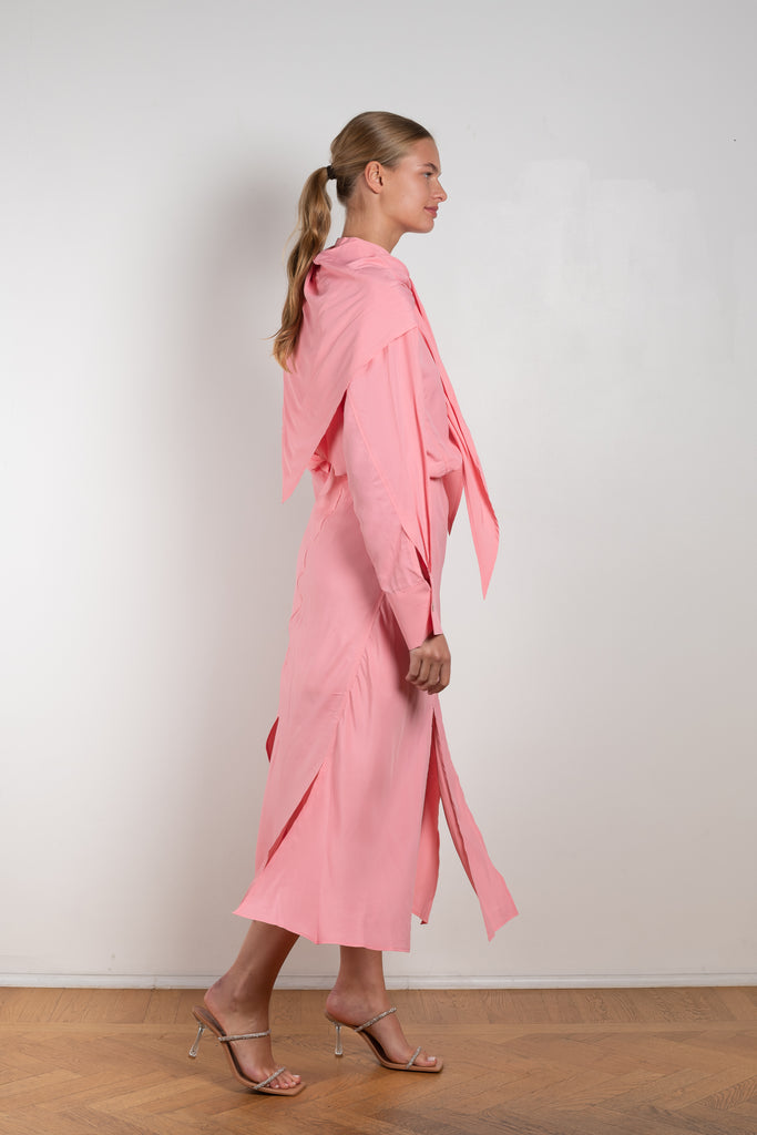 The Remi Skirt by Rejina Pyo is a high waisted midi length skirt with slits and deconstructed panels in a pink fluid viscose