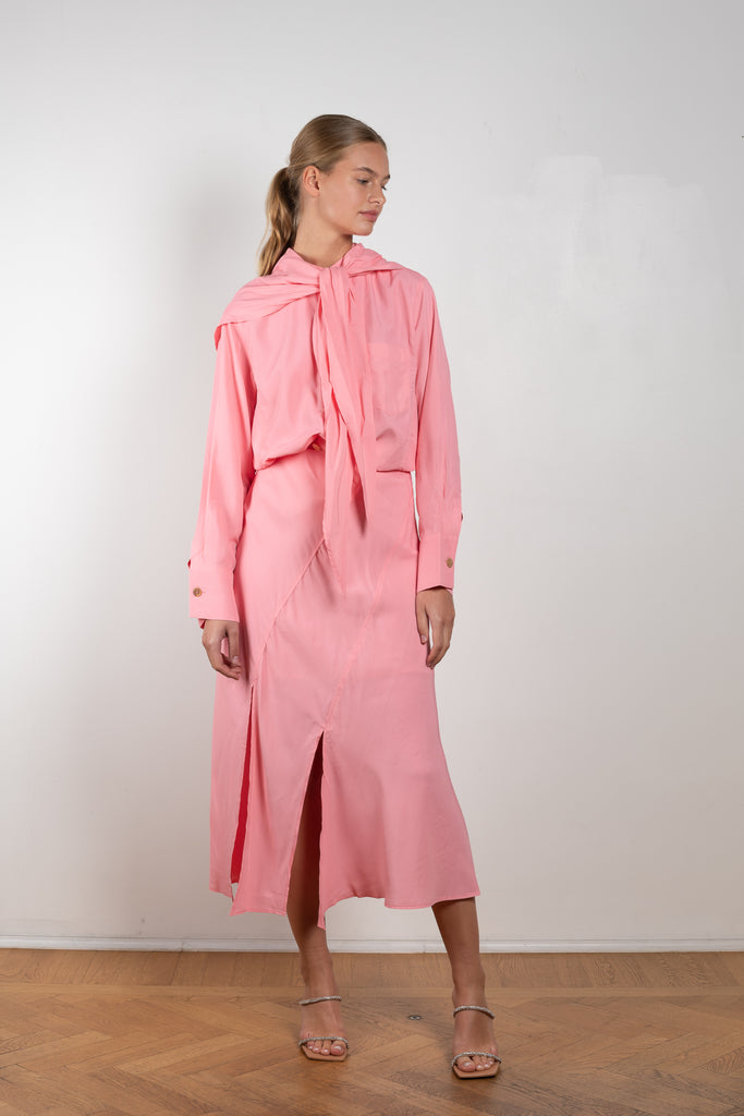 The Remi Skirt by Rejina Pyo is a high waisted midi length skirt with slits and deconstructed panels in a pink fluid viscose