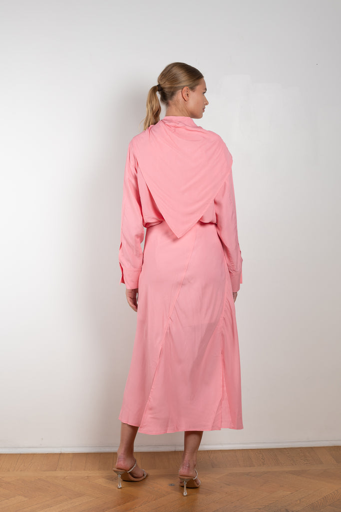 The Remi Skirt by Rejina Pyo is a high waisted midi length skirt with slits and deconstructed panels in a pink fluid viscose