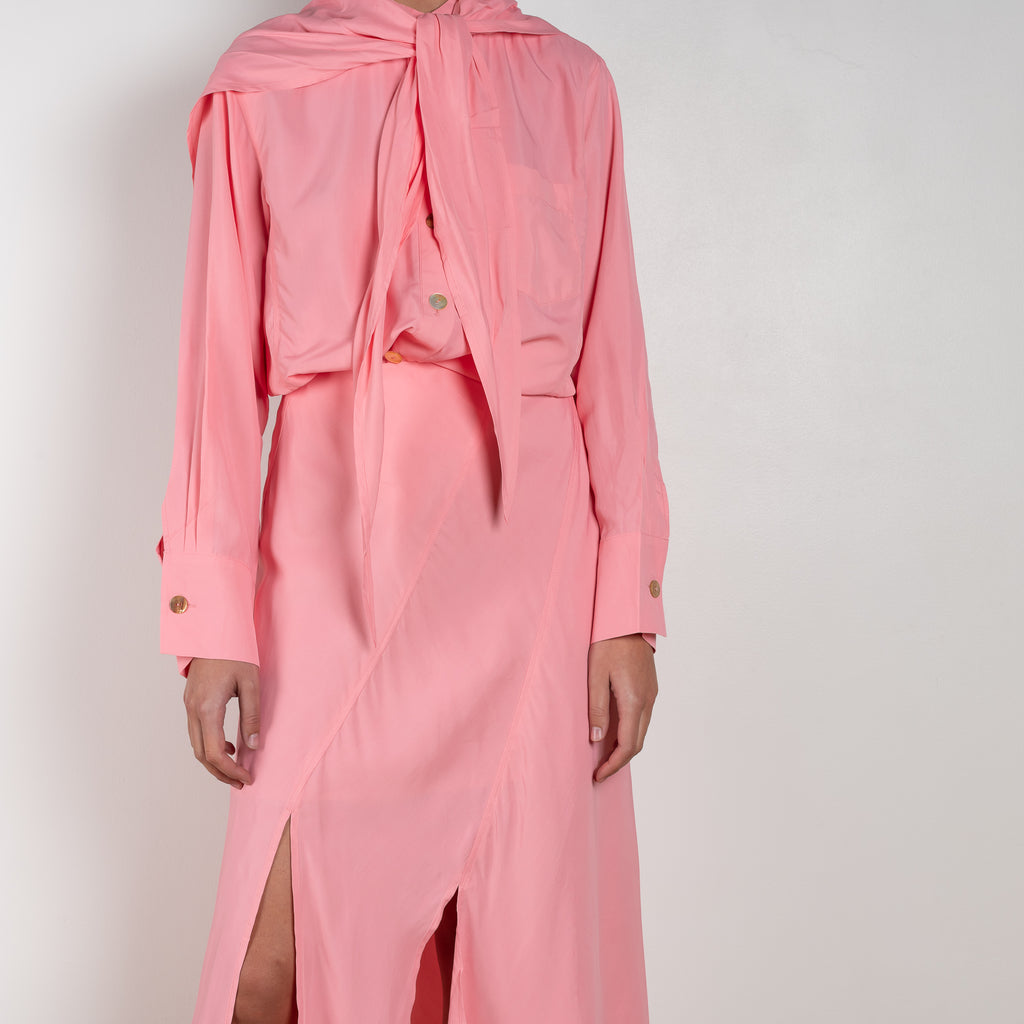 The Remi Skirt by Rejina Pyo is a high waisted midi length skirt with slits and deconstructed panels in a pink fluid viscose