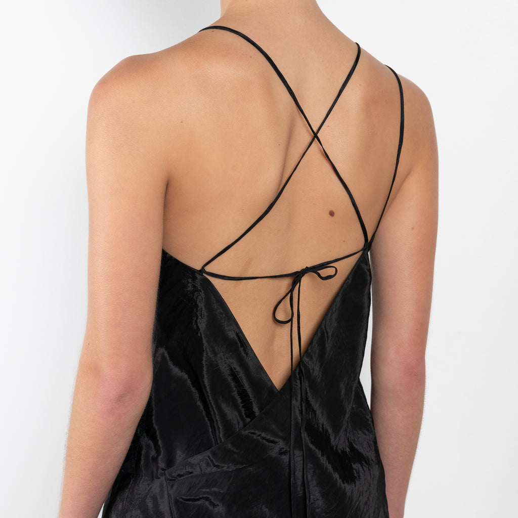 The Sabine Dress by Rejina Pyo is a made in a crinkle viscose blend with an asymmetrical front slit, an adjustable back tie and custom hardware