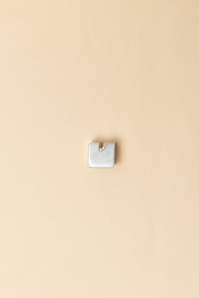 The Croissant Trois Earring by Sophie Bille Brahe is a smaller, delicate earring featuring three diamonds graduating in size which lends perfectly to mix and match other SBB pieces