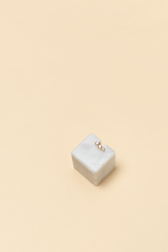 The Croissant Trois Earring by Sophie Bille Brahe is a smaller, delicate earring featuring three diamonds graduating in size which lends perfectly to mix and match other SBB pieces
