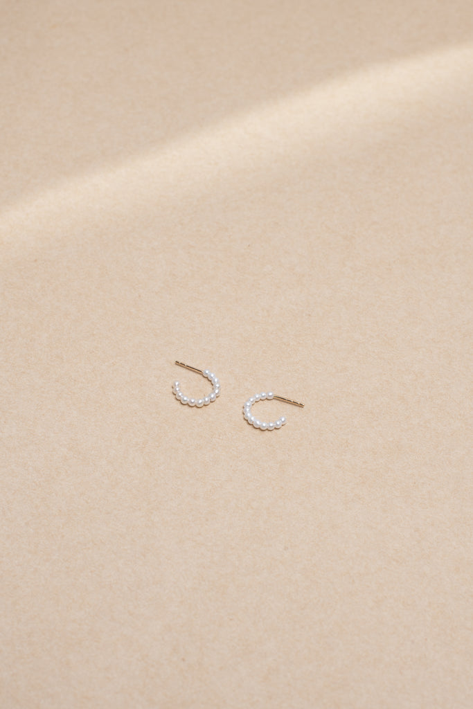 The Marco Earrings by Sophie Bille Brahe are small 14Kt Gold hoop earrings with freshwater pearls