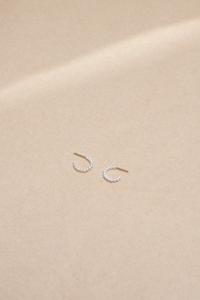 The Marco Earrings by Sophie Bille Brahe are small 14Kt Gold hoop earrings with freshwater pearls
