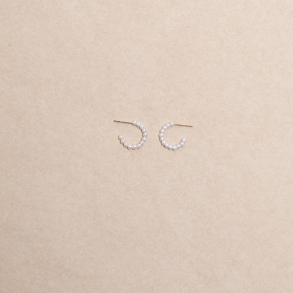 The Marco Earrings by Sophie Bille Brahe are small 14Kt Gold hoop earrings with freshwater pearls