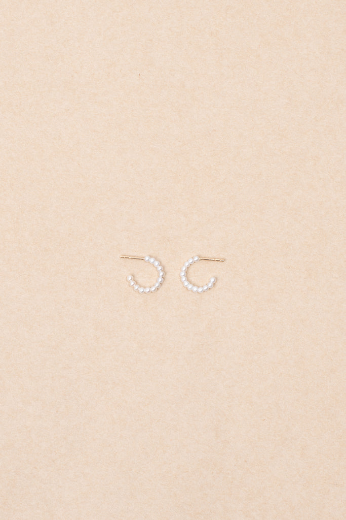 The Marco Earrings by Sophie Bille Brahe are small 14Kt Gold hoop earrings with freshwater pearls