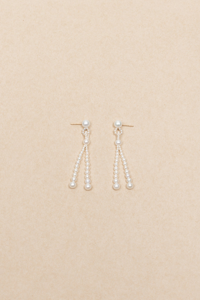The Opera Earrings by Sophie Bille Brahe are statement drop earrings with white freshwater pearls graduating in size