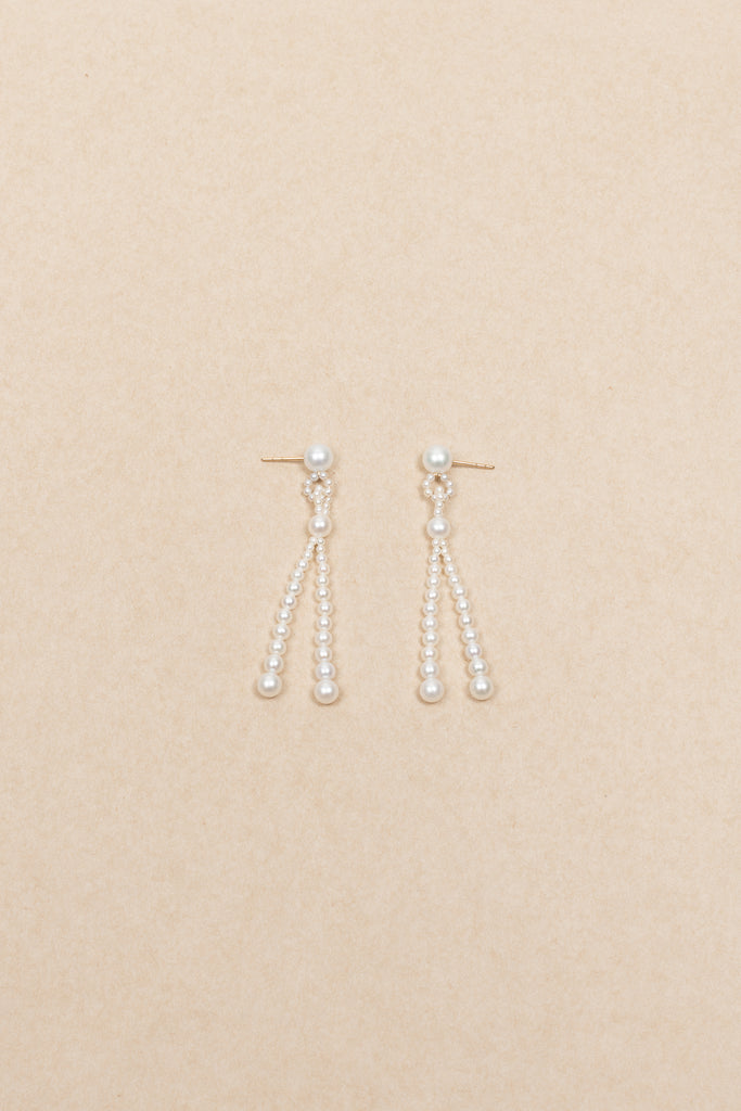 The Opera Earrings by Sophie Bille Brahe are statement drop earrings with white freshwater pearls graduating in size
