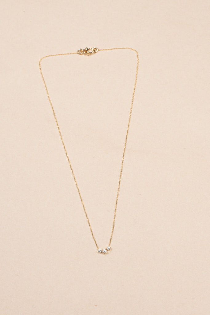 The Orangerie Trois Necklace by Sophie Bille Brahe has three petite diamonds that sit loose on the delicate gold chain allowing them to move elegantly as the necklace is worn