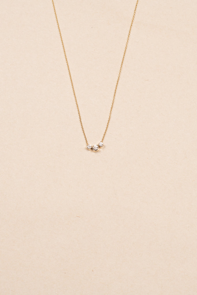 The Orangerie Trois Necklace by Sophie Bille Brahe has three petite diamonds that sit loose on the delicate gold chain allowing them to move elegantly as the necklace is worn