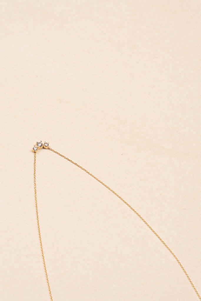 The Orangerie Trois Necklace by Sophie Bille Brahe has three petite diamonds that sit loose on the delicate gold chain allowing them to move elegantly as the necklace is worn