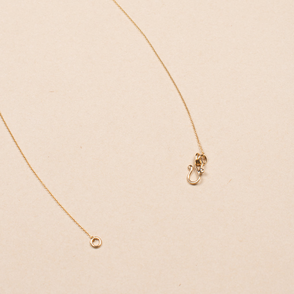 The Orangerie Trois Necklace by Sophie Bille Brahe has three petite diamonds that sit loose on the delicate gold chain allowing them to move elegantly as the necklace is worn