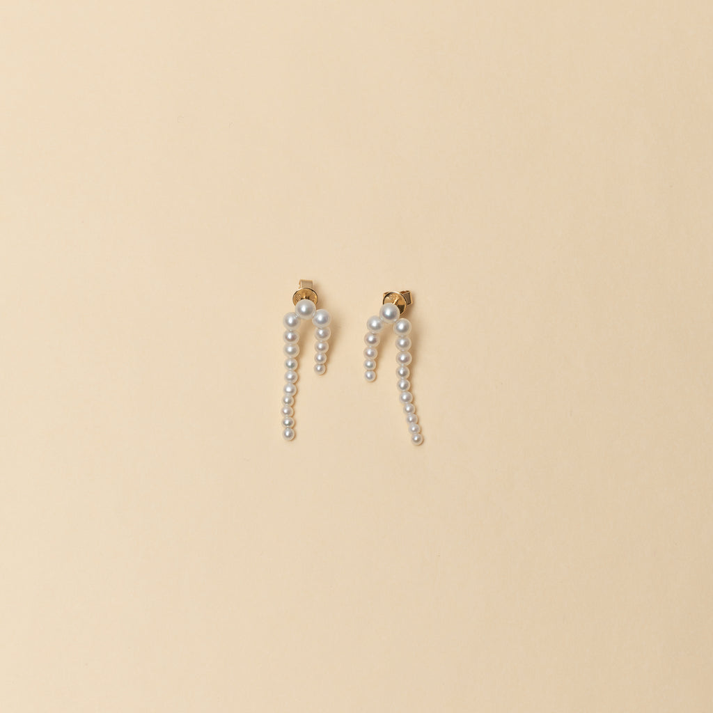 The Petite Perle Nuit Earrings by Sophie Bille Brahe are 14Kt Gold earrings with dropdown freshwater pearls descending in size