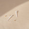 The Sienna Earrings by Sophie Bille Brahe are 14Kt Gold earrings with a dropdown of 9 Freshwater pearls