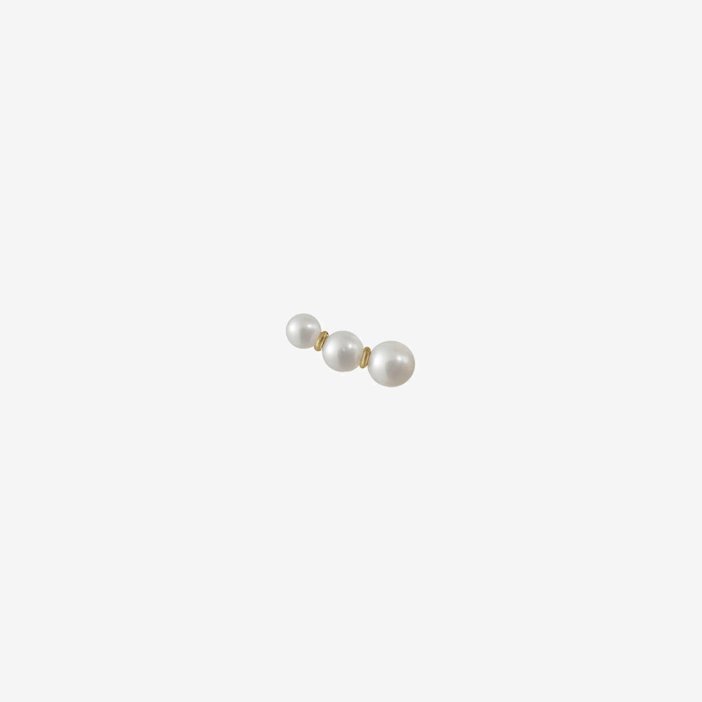 The Trois Perle Earring by Sophie Bille brahe is a delicate earring with pearls graduating in size, handcrafted in 14K yellow gold with freshwater pearls