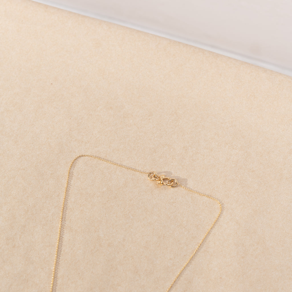 The Conque d'Or Diamant by Sophie Bille Brahe is a delicate Necklace with a Conque pendant in 18K yellow gold with 0,18 ct Top Wesselton VVS diamonds