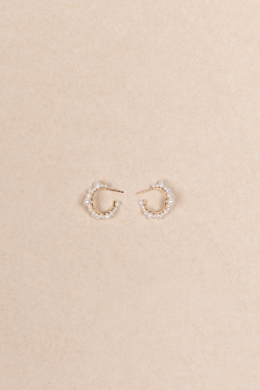 The Mary Hoop Earrings by Sophie Bille Brahe are Hoop earrings featuring white freshwater pearls varying in size, arranged intricately