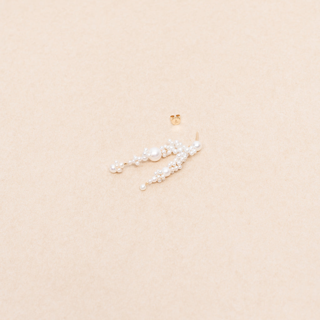 The Fontaine Nuit Earring by Sophie Bille Brahe is a statement drop earring with white freshwater pearls varying in size