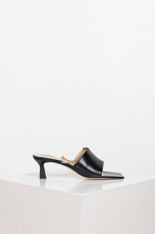 The Isa Chain Mules by Wandler are kitten heel mules with a squared toe silhouette and a feminine chain detail