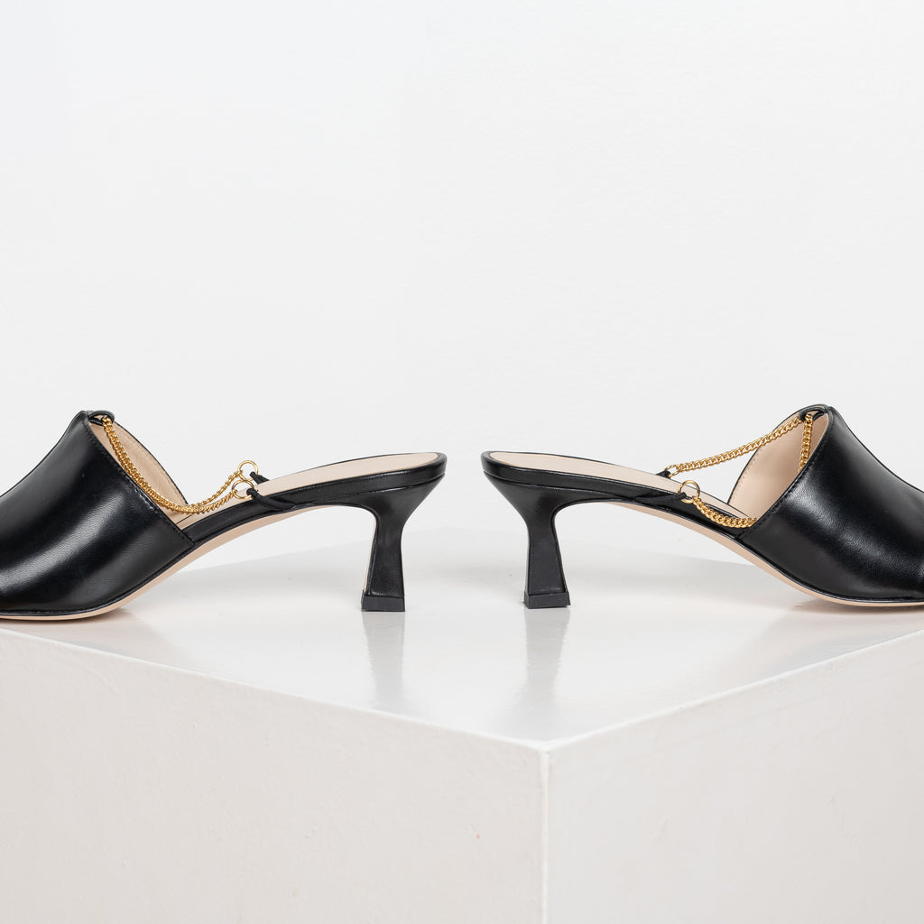The Isa Chain Mules by Wandler are kitten heel mules with a squared toe silhouette and a feminine chain detail